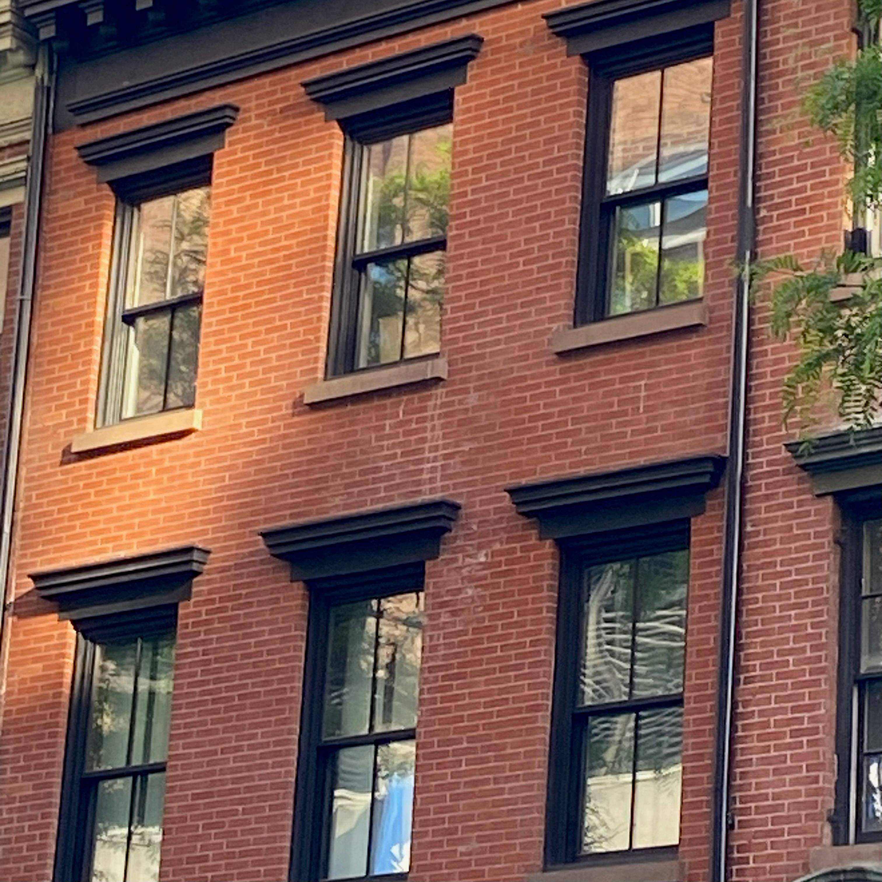 Two rows of windows from a brick building.