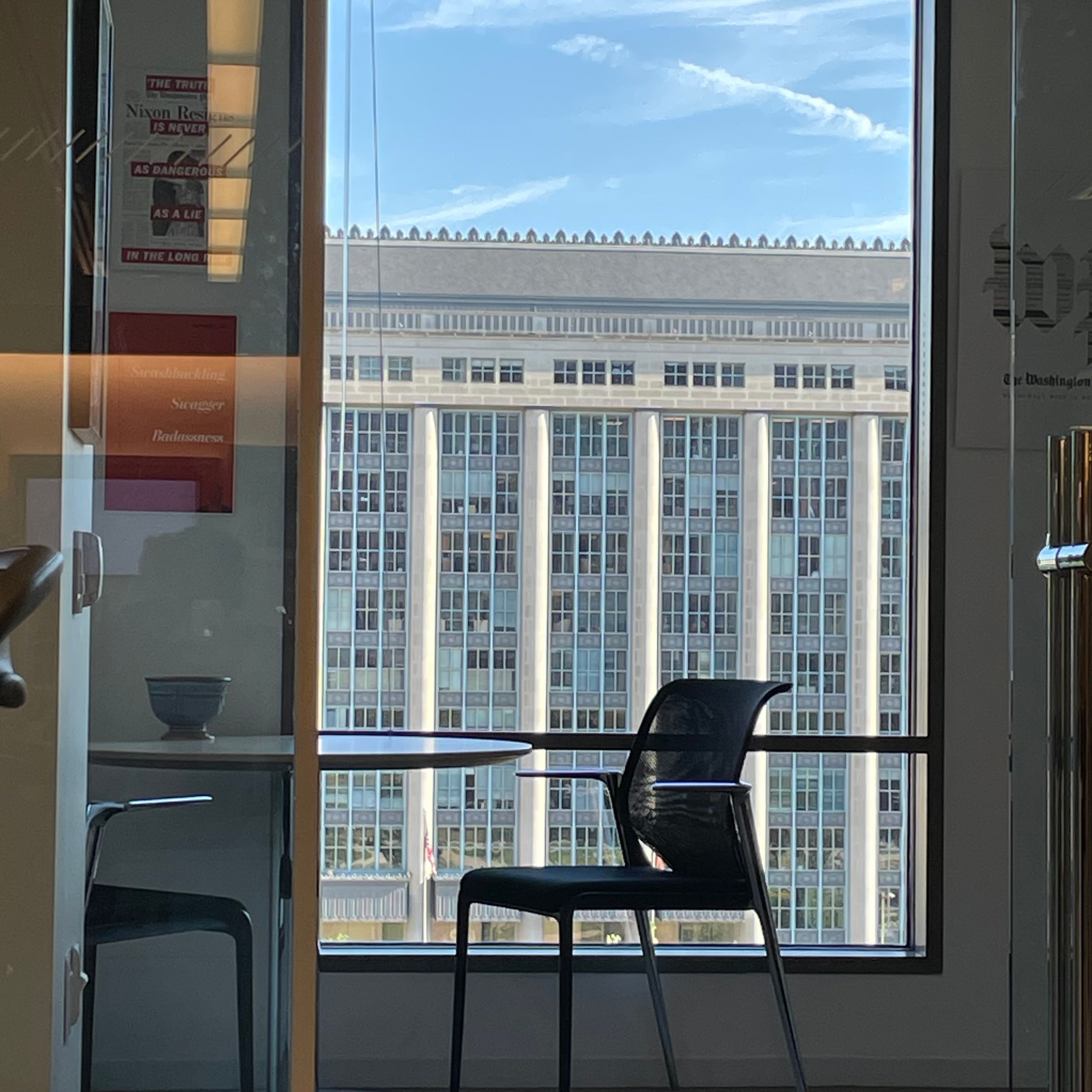 An office with a window view of another building.