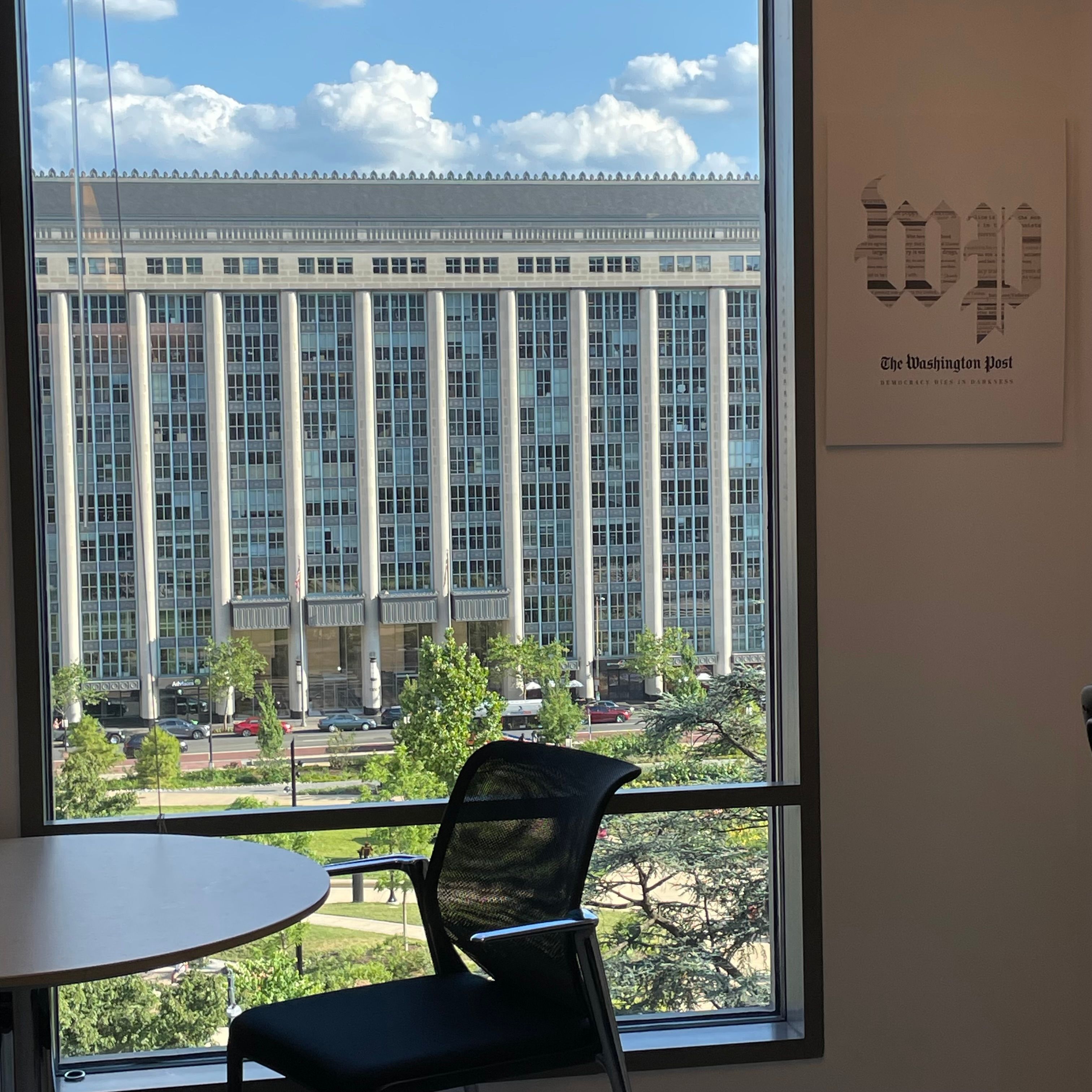 A window next to a Washington Post sign.